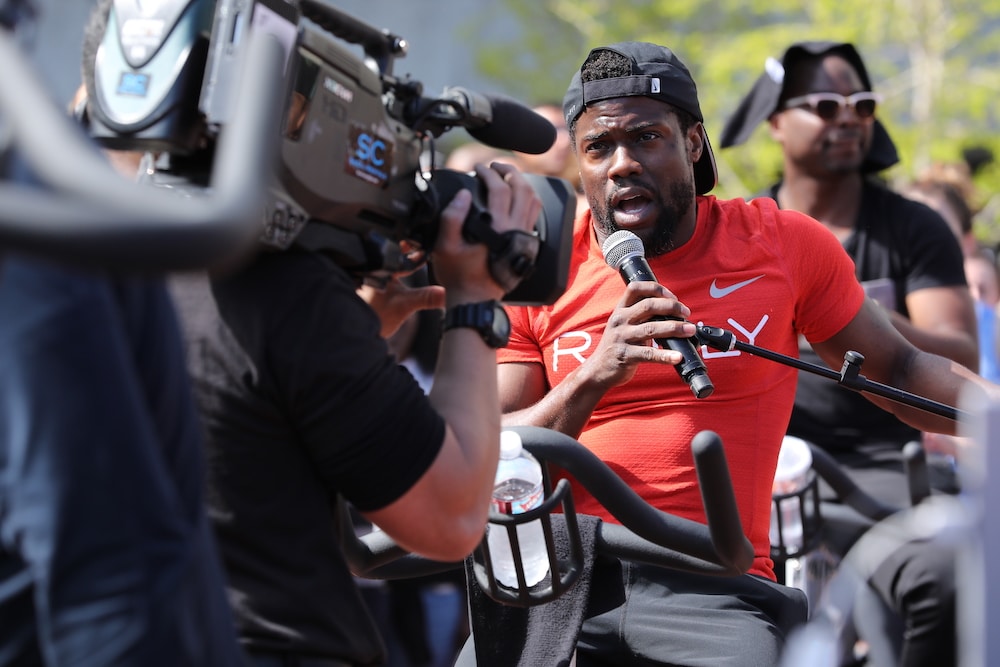 kevin hart speaks into microphone at Rally Health event by ProGlobalEvents