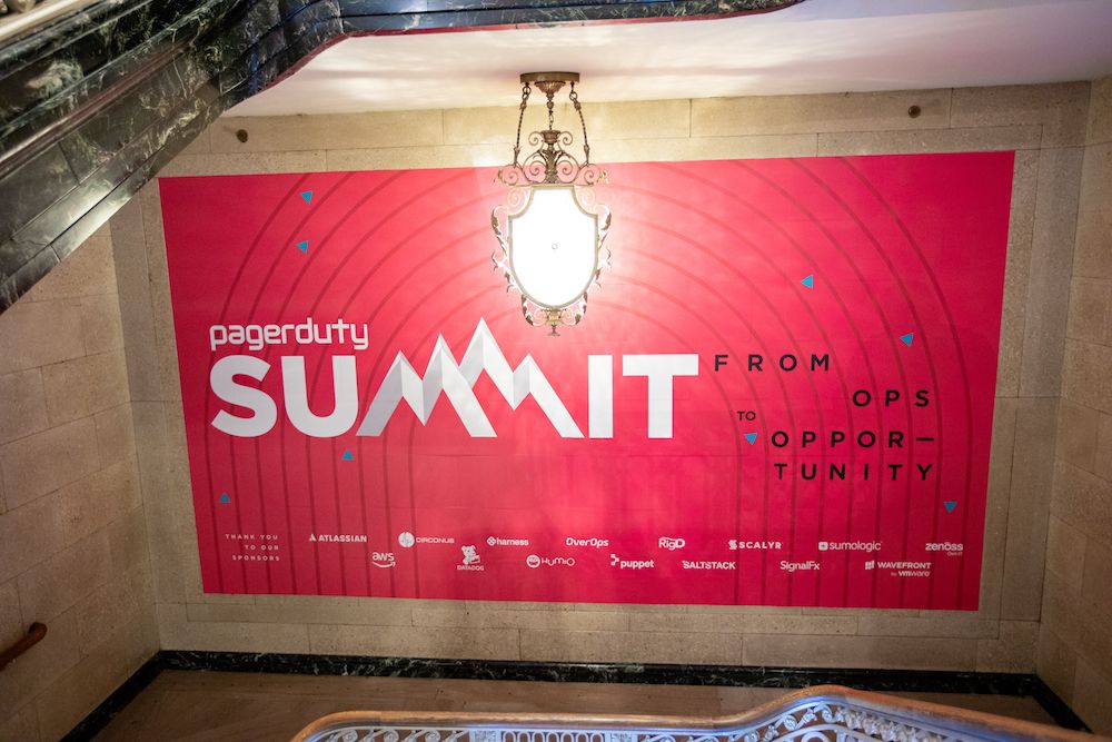 large red pagerduty summit sign on wall at event
