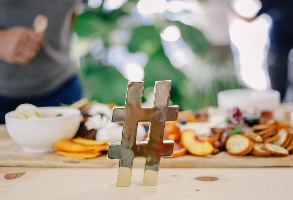 model hashtag on table in front of food